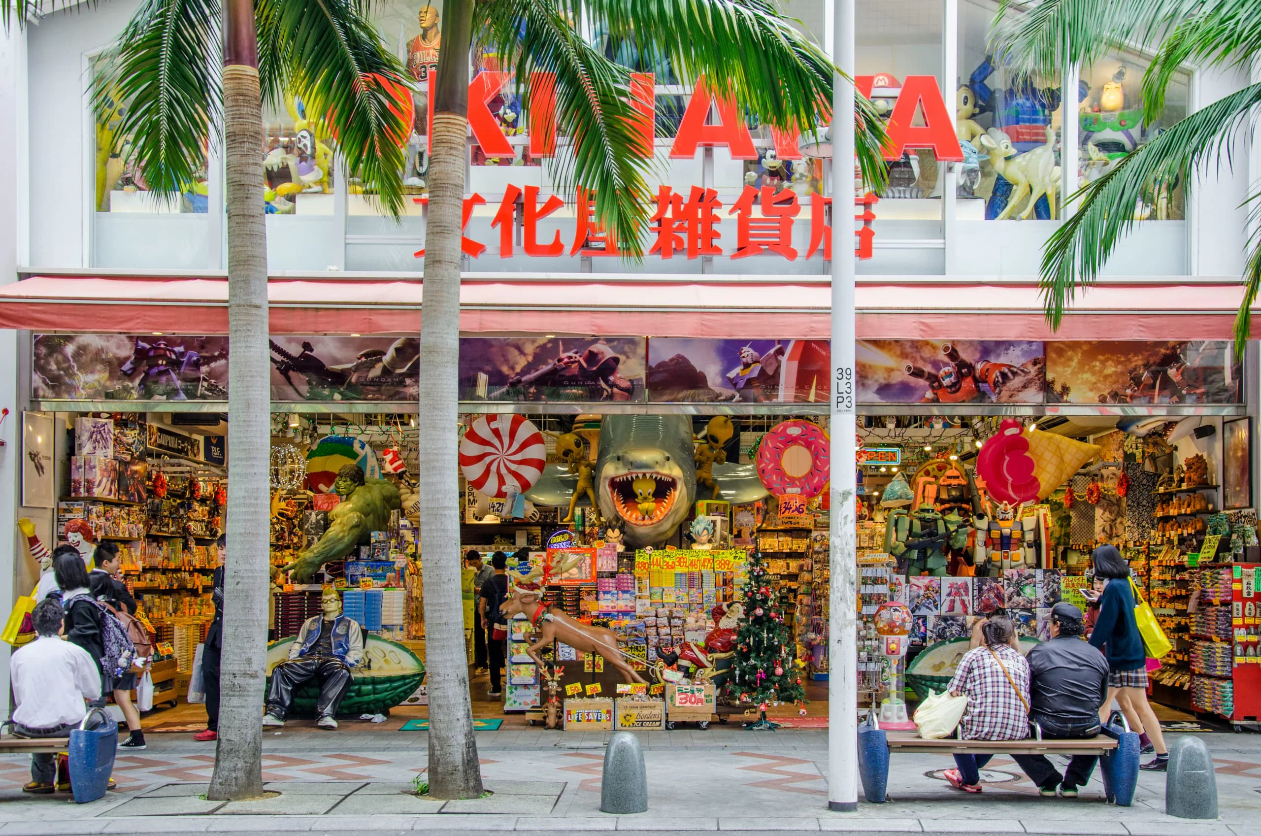 A colourful toy and souvenir shopfront under palm trees in Okinawa