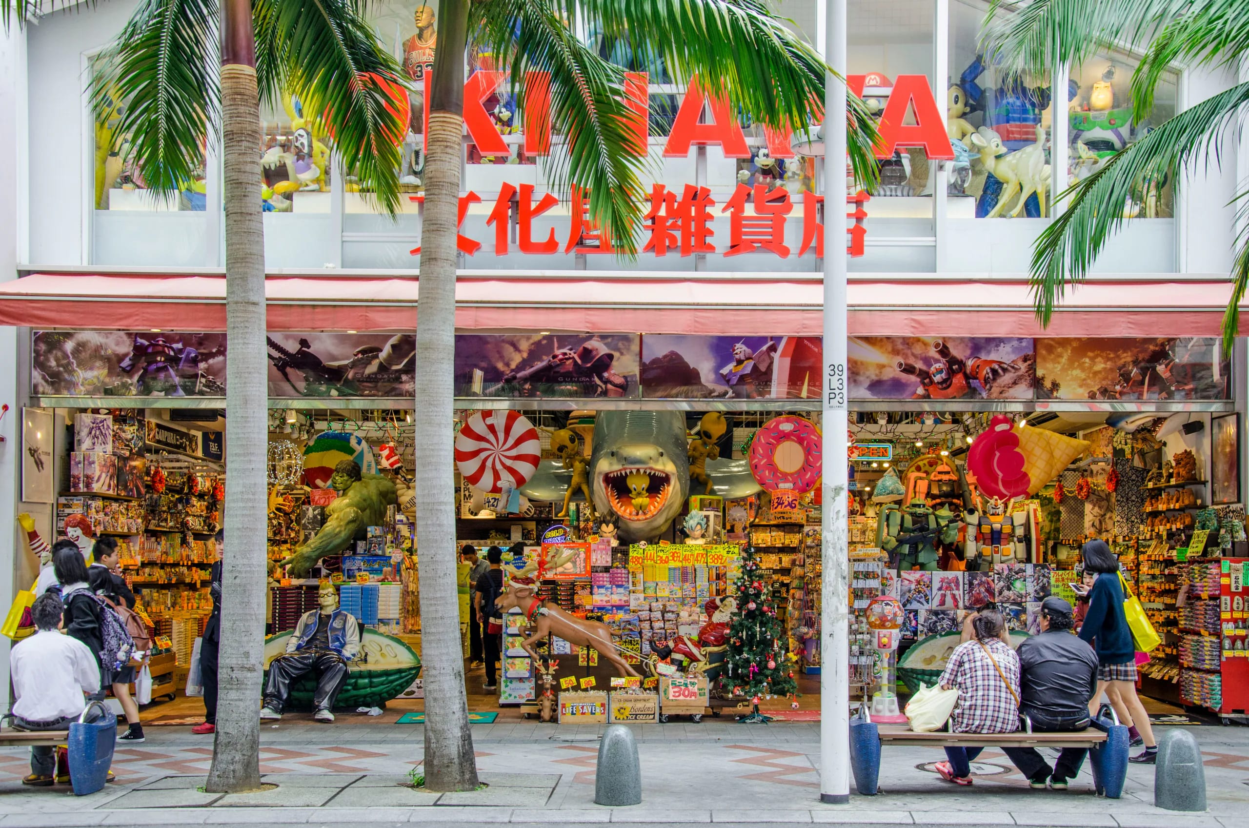 A colourful toy and souvenir shopfront under palm trees in Okinawa